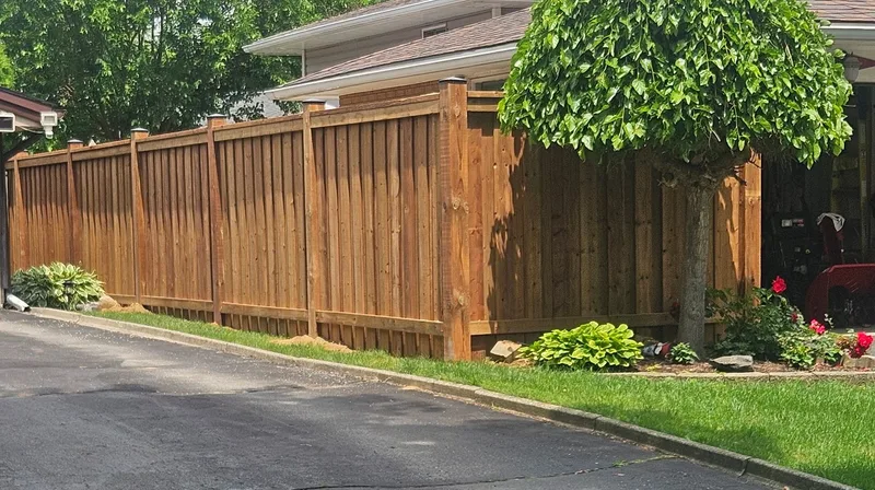 Privacy fence running along a residential property beside the driveway