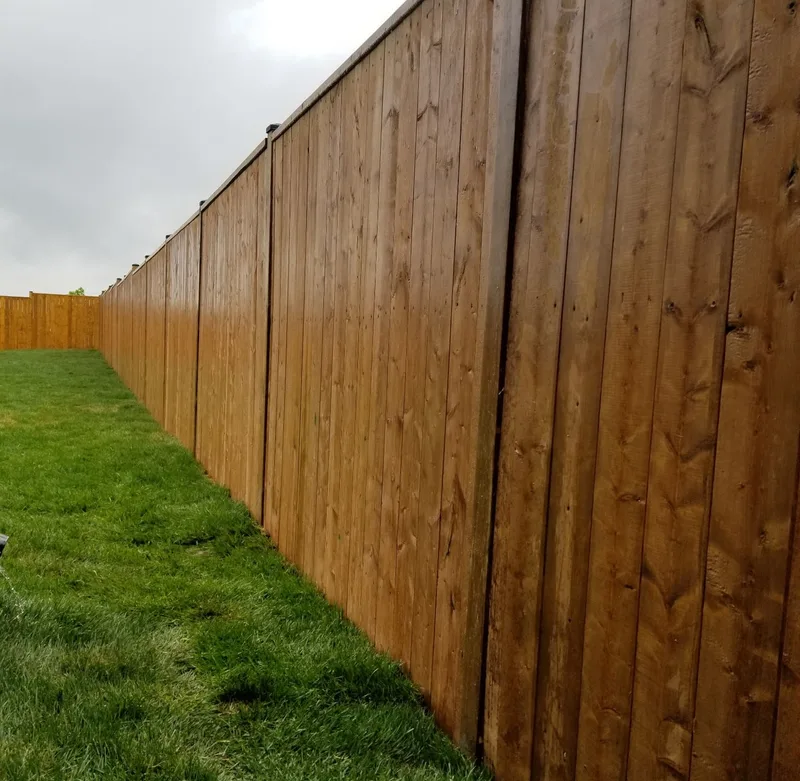 Long board fence bordering an open lawn