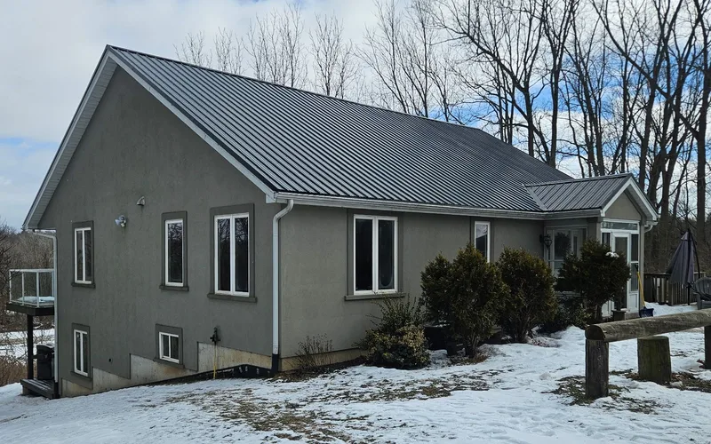 Grey home with a finished steel roof