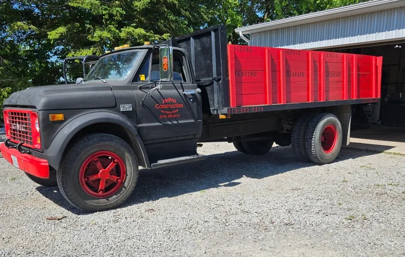 JerPro Construction’s black and red work truck parked outside a workshop